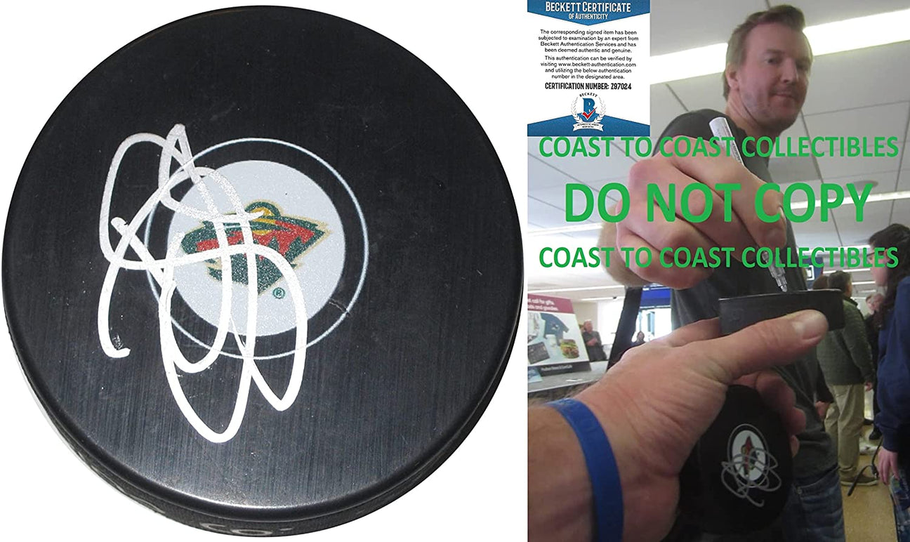 Devan Dubnyk signed Minnesota Wild logo Hockey puck proof Beckett COA autographed